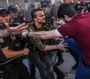 An LGBT activist is kicked by a plain-clothed police officer at banned Istanbul Pride 2017