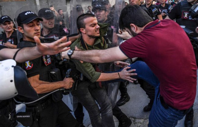 An LGBT activist is kicked by a plain-clothed police officer at banned Istanbul Pride 2017