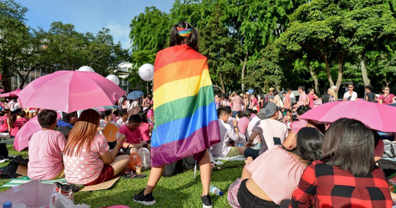 A supporter wrapped in a rainbow flag attends the annual "Pink Dot" event in a public show of support for the LGBT community at Hong Lim Park in Singapore on July 1, 2017. Thousands of Singaporeans took part in the gay-rights rally on July 1. / AFP PHOTO / Roslan RAHMAN (Photo credit should read ROSLAN RAHMAN/AFP/Getty Images)