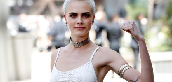 British model and actress Cara Delevingne poses during the photocall before Chanel 2017-2018 fall/winter Haute Couture collection show in Paris on July 4, 2017. / AFP PHOTO / Patrick KOVARIK (Photo credit should read PATRICK KOVARIK/AFP/Getty Images)