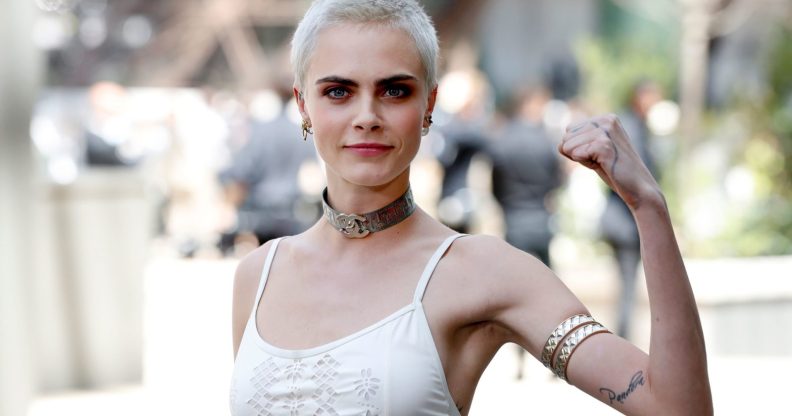 British model and actress Cara Delevingne poses during the photocall before Chanel 2017-2018 fall/winter Haute Couture collection show in Paris on July 4, 2017. / AFP PHOTO / Patrick KOVARIK (Photo credit should read PATRICK KOVARIK/AFP/Getty Images)