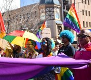 Dozens of people cheer and dance as they take part in the Namibian Lesbians, Gay, Bisexual and Transexual (LGBT) community pride Parade in the streets of the Namibian Capitol on July 29, 2017 in Windhoek. Even though there have been marches and protests against discrimination against the LGBT community in the past years, this is the first time that the community held such a parade along the capital's main street, Independence Avenue, to celebrate their identity and rights. / AFP PHOTO / Hildegard Titus (Photo credit should read HILDEGARD TITUS/AFP/Getty Images)