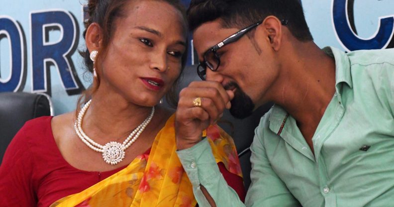 Nepali transgender woman Monika Shahi Nath (L) talks with her husband Ramesh Nath (R) during a press conference to announce the registration of their marriage, in Kathmandu on August 5, 2017. A Nepali transgender woman and a man registered their marriage, a first in the country, the couple said on August 5, despite an absence of laws legalising same-sex or transgender unions. Monika Shahi Nath, 40, who legally identifies as a third gender, married Ramesh Nath Yogi, 22, in May and was able to register it in their home district Dadeldhura in western Nepal last month. / AFP PHOTO / PRAKASH MATHEMA (Photo credit should read PRAKASH MATHEMA/AFP/Getty Images)