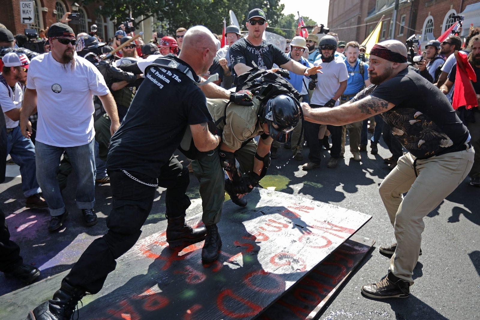 CHARLOTTESVILLE, VA - AUGUST 12: White nationalists, neo-Nazis, the KKK and members of the "alt-right" attack each other as a counter protester (R) intervenes during the melee outside Emancipation Park during the Unite the Right rally August 12, 2017 in Charlottesville, Virginia. After clashes with anti-fascist protesters and police the rally was declared an unlawful gathering and people were forced out of Lee Park, where a statue of Confederate General Robert E. Lee is slated to be removed. (Photo by Chip Somodevilla/Getty Images)