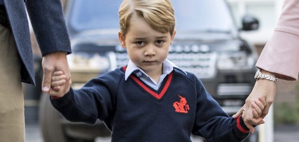 TOPSHOT - Britain's Prince George (C) accompanied by Britain's Prince William (L), Duke of Cambridge arrives for his first day of school at Thomas's school where he is met by Helen Haslem (R) head of the lower school in southwest London on September 7, 2017. / AFP PHOTO / POOL / RICHARD POHLE (Photo credit should read RICHARD POHLE/AFP/Getty Images)