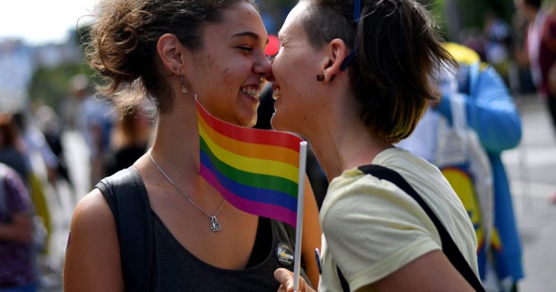 TOPSHOT - Two women react during the Gay Pride parade on September 17, 2017 in Belgrade. Serbia's lesbian prime minister on September 17 joined hundreds of activists with rainbow flags for Belgrade's annual gay pride march, an event held under heavy security in the conservative country. Belgrade's first Pride march, in 2001, ended with police firing in the air to disperse anti-gay nationalists and skinheads who stoned and beat participants. / AFP PHOTO / ANDREJ ISAKOVIC (Photo credit should read ANDREJ ISAKOVIC/AFP/Getty Images)