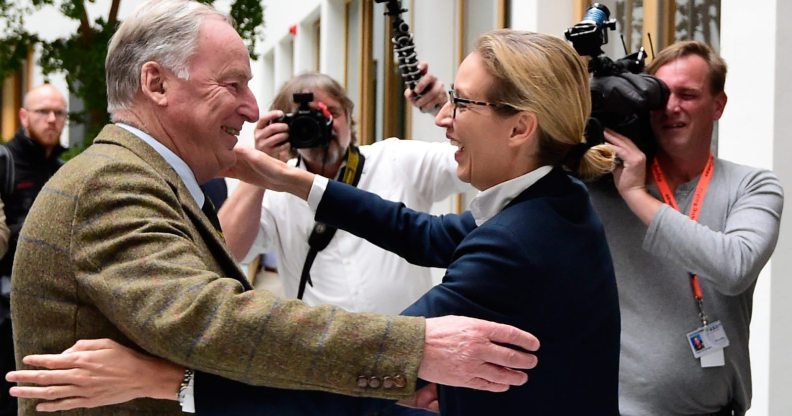 Alexander Gauland (L) and Alice Weidel, both top candidates of Germany's nationalist Alternative for Germany (AfD) party, hug prior to a press conference in Berlin on September 25, 2017, one day after general elections. The election spelt a breakthrough for the anti-Islam Alternative for Germany (AfD), which with 12.6 percent became the third strongest party and vowed to "go after" chancellor Angela Merkel over her migrant and refugee policy. / AFP PHOTO / Tobias SCHWARZ (Photo credit should read TOBIAS SCHWARZ/AFP/Getty Images)