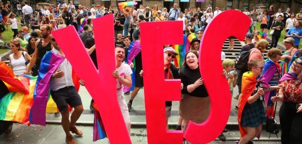 MELBOURNE, AUSTRALIA - NOVEMBER 15: People in the crowd celebrate as the result is announced during the Official Melbourne Postal Survey Result Announcement at the State Library of Victoria on November 15, 2017 in Melbourne, Australia. Australians have voted for marriage laws to be changed to allow same-sex marriage, with the Yes vote defeating No. Despite the Yes victory, the outcome of Australian Marriage Law Postal Survey is not binding, and the process to change current laws will move to the Australian Parliament in Canberra. (Photo by Scott Barbour/Getty Images)