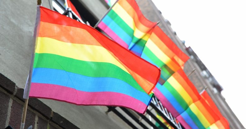 LGBT+ Pride flags flutter in the breeze from a building