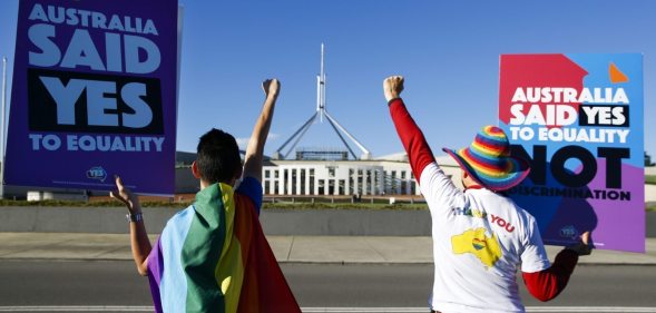 Equality ambassadors and volunteers from the Equality Campaign celebrate as they gather in front of Parliament House in Canberra on December 7, 2017, ahead of the parliamentary vote on Same Sex Marriage, which will take place later today in the House of Representatives. / AFP PHOTO / SEAN DAVEY