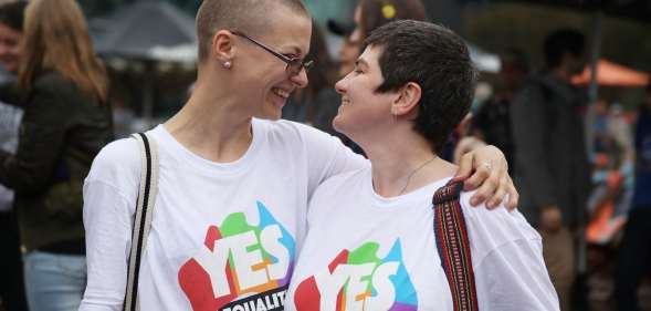 MELBOURNE, AUSTRALIA - DECEMBER 07: Tracy Clark and her partner Justyna Greinart embrace as they gather with a crowd of people to watch a large television screen at Federation Square as it is announced that same-sex marriage will be legal in Australia with Parliament agreeing to change the Marriage Act and end the ban on gay and lesbian couples marrying on December 7, 2017 in Melbourne, Australia. The historic bill was passed on the final day of parliamentart sitting for 2017. The legislation means same-sex couples will now be able to be legally married in Australia. Australians voted 'Yes' in the Marriage Law Postal Survey for the law to be changed in November. (Photo by Scott Barbour/Getty Images)