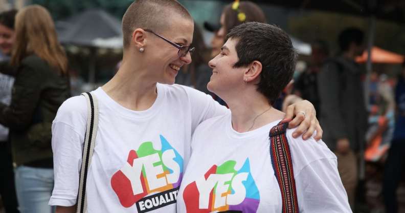 MELBOURNE, AUSTRALIA - DECEMBER 07: Tracy Clark and her partner Justyna Greinart embrace as they gather with a crowd of people to watch a large television screen at Federation Square as it is announced that same-sex marriage will be legal in Australia with Parliament agreeing to change the Marriage Act and end the ban on gay and lesbian couples marrying on December 7, 2017 in Melbourne, Australia. The historic bill was passed on the final day of parliamentart sitting for 2017. The legislation means same-sex couples will now be able to be legally married in Australia. Australians voted 'Yes' in the Marriage Law Postal Survey for the law to be changed in November. (Photo by Scott Barbour/Getty Images)