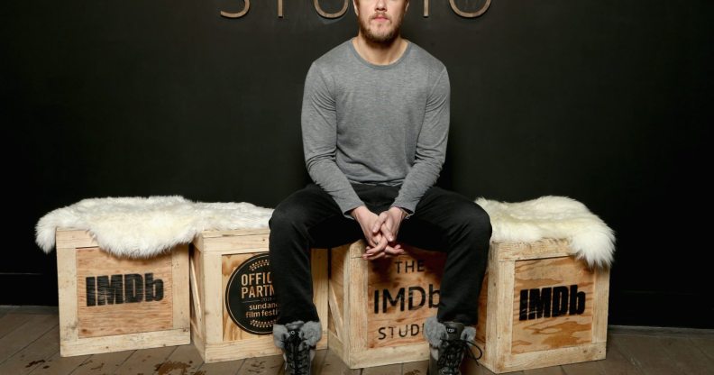 Singer Dan Reynolds sits on a box.