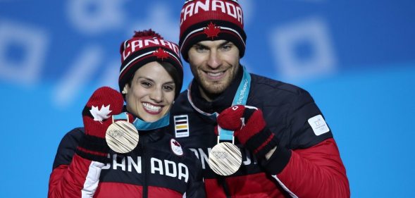 PYEONGCHANG-GUN, SOUTH KOREA - FEBRUARY 15: Bronze medalists Meagan Duhamel and Eric Radford of Canada celebrate during the medal ceremony for the Pair Skating Free Skating on day six of the PyeongChang 2018 Winter Olympic Games at Medal Plaza on February 15, 2018 in Pyeongchang-gun, South Korea. (Photo by Clive Mason/Getty Images)