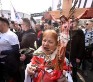 A woman holds a cross as opponents to a treaty safeguarding women, backed by the Roman Catholic Church, protest against its ratification arguing it is imposing what they call a "gender ideology in the Croatian capital, Zagreb, on March 24, 2018. Protestors against the Council of Europe convention -- the world's first binding instrument to prevent and combat violence against women, from marital rape to female genital mutilation -- hold banners against its ratification, an issue that has split the Balkan country. / AFP PHOTO / STR (Photo credit should read STR/AFP/Getty Images)