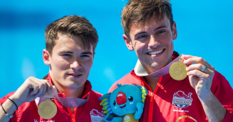 England's Thomas Daley (R) and Daniel Goodfellow pose with their gold medals after the men's synchronised 10m platform diving in the 2018 Gold Coast Commonwealth Games at the Optus Aquatic Centre on the Gold Coast on April 13, 2018 / AFP PHOTO / François-Xavier MARIT / The erroneous mention[s] appearing in the metadata of this photo by François-Xavier MARIT has been modified in AFP systems in the following manner: [gold medals] instead of [silver medals (as previously corrected)]. Please immediately remove the erroneous mention[s] from all your online services and delete it (them) from your servers. If you have been authorized by AFP to distribute it (them) to third parties, please ensure that the same actions are carried out by them. Failure to promptly comply with these instructions will entail liability on your part for any continued or post notification usage. Therefore we thank you very much for all your attention and prompt action. We are sorry for the inconvenience this notification may cause and remain at your disposal for any further information you may require. (Photo credit should read FRANCOIS-XAVIER MARIT/AFP/Getty Images)