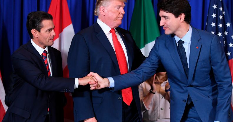 Mexico's President Enrique Pena Nieto shakes hands with Canadian Prime Minister Justin Trudeau next to US President Donald Trump after signing the USMCA agreement