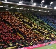 Watford FC fans make a huge Pride flag in the stands