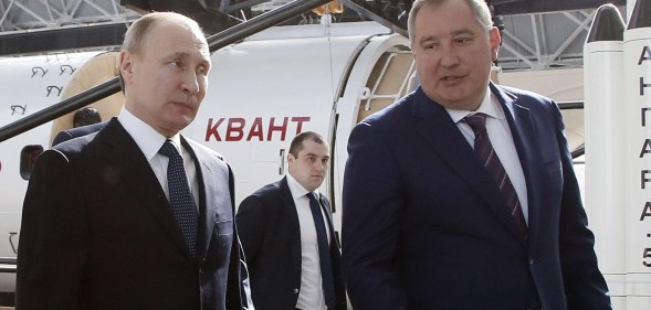 Russian President Vladimir Putin talks with Russian Deputy Prime Minister and Head of ROSCOSMOS Dmitry Rogozin