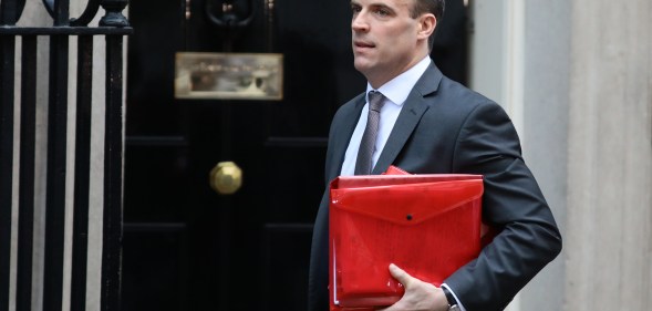 Dominc Raab carrying a red ministerial box