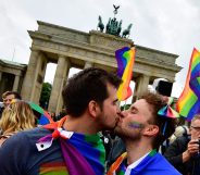 TOPSHOT - Two men kiss as they attend a rally of gays and lesbians in front of the Brandenburg Gate in Berlin on June 30, 2017. The German parliament legalised same-sex marriage, days after Chancellor Angela Merkel said she would allow her conservative lawmakers to follow their conscience in the vote. / AFP PHOTO / Tobias SCHWARZ (Photo credit should read TOBIAS SCHWARZ/AFP/Getty Images)