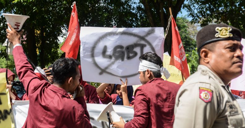 A group of Muslim protesters march with banners against the LGBT community in Banda Aceh on Decmber 27, 2017