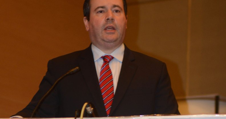 Jason Kenney speaking into a microphone