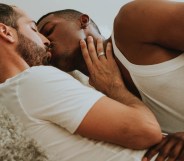 Two men kiss on a couch in an example of softcore porn