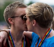 Gay stories: gay kiss with people where rainbow pride lanyards