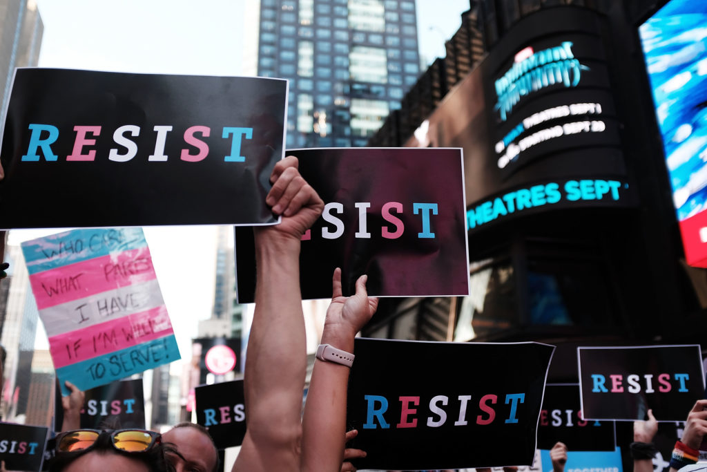 Dozens of protesters gather in Times Square near a military recruitment center to show their anger at President Donald Trump's decision to reinstate a ban on trans folk from serving in the militar. (Spencer Platt/Getty Images)