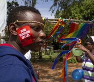 A Ugandan man with a sticker on his face takes part on August 9, 2014 in the annual gay pride in Entebbe, Uganda