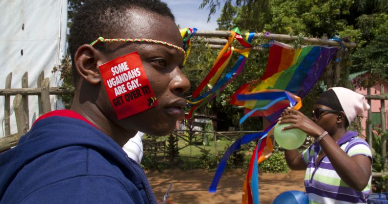 A Ugandan man with a sticker on his face takes part on August 9, 2014 in the annual gay pride in Entebbe, Uganda