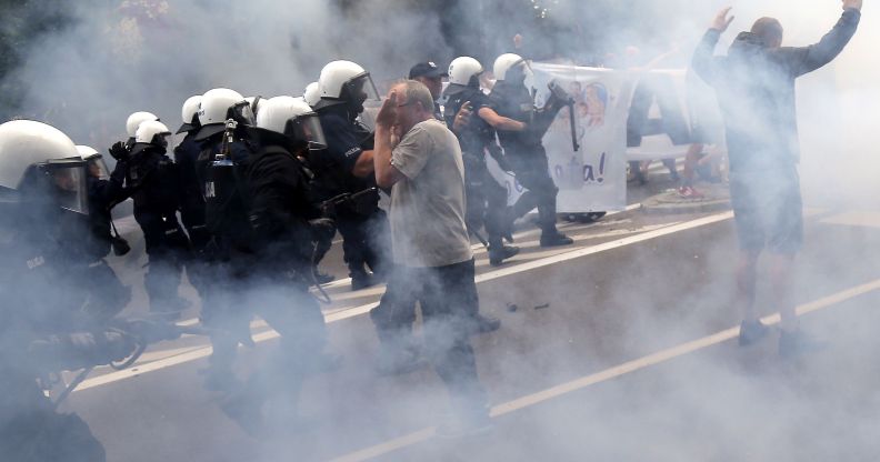 Riot police fire tear gas to disperse people, including ultra-nationalists, who attempted to block the first gay pride march on July 20, 2019 in Bialystok, eastern Poland