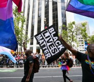 Men wave rainbow and 'black lives matter' flags while marching in the annual LGBTQI Pride Parade on Sunday, June 25, 2017 in San Francisco, California.