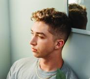 man sitting against wall