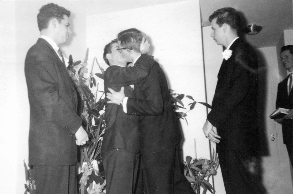 Two grooms kissing