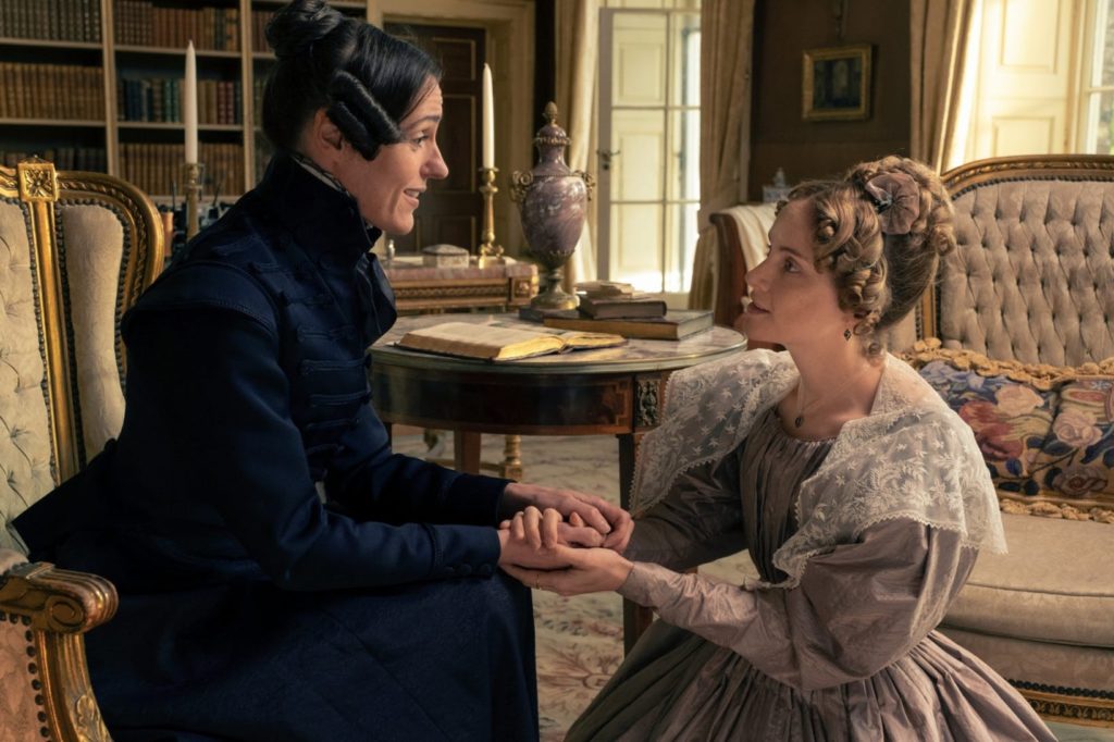 Anne Lister sitting down, holding hands with Ann Walker who is on bended knee