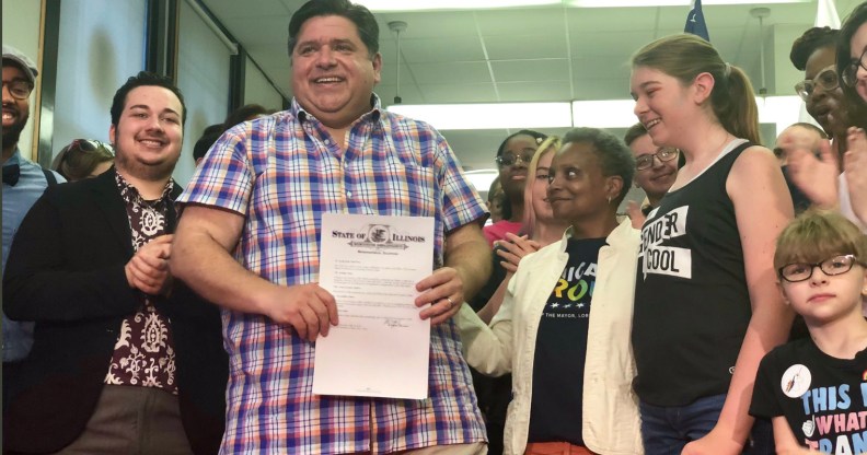 Illinois Governor J.B. Pritzker holds his executive order alongside Chicago Mayor Lori Lightfoot.