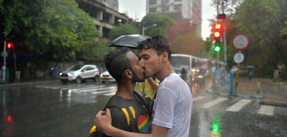 Two men kissing in the rain during a Pride event in Kolkata