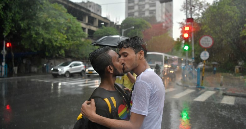 Two men kissing in the rain during a Pride event in Kolkata