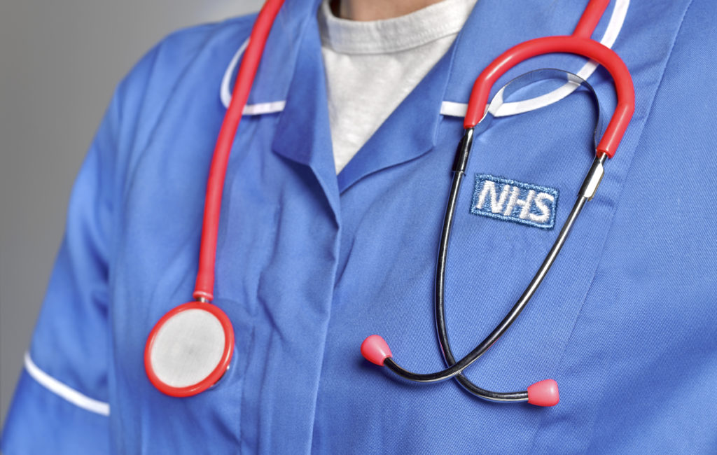 An NHS staff member wearing a stethoscope