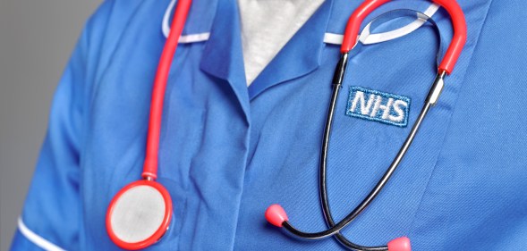 An NHS staff member wearing a stethoscope