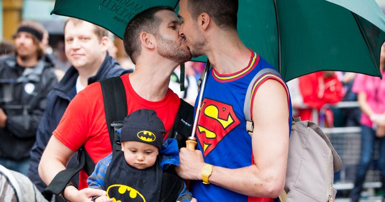 Two men share a kiss as they take part in the LGBT parade during the annual Pride In London parade on June 28, 2014 in London, England.