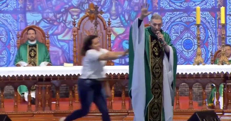 Woman pushes anti-gay priest off stage in Brazil