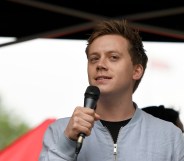 Guardian columnist Owen Jones speaks to the crowd during an Anti-Trump protest in London.