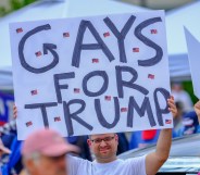 LGB Republican holds banner that reads 'Gays for Trump'