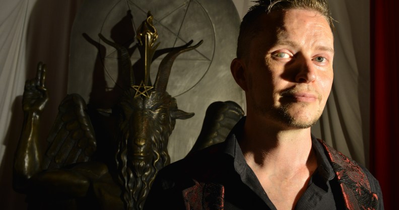 Lucien Greaves, spokesman for The Satanic Temple, with a statue of Baphomet at the group's meeting house in Salem, Massachusetts.