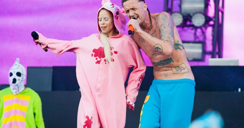 Die Antwoord's Yolandi in a pink onesie and Ninja in blue trousers