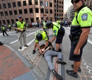 Boston Police officers arrest an anti-parade demonstrator during the "Straight Pride" parade in Boston, on August 31, 2019.