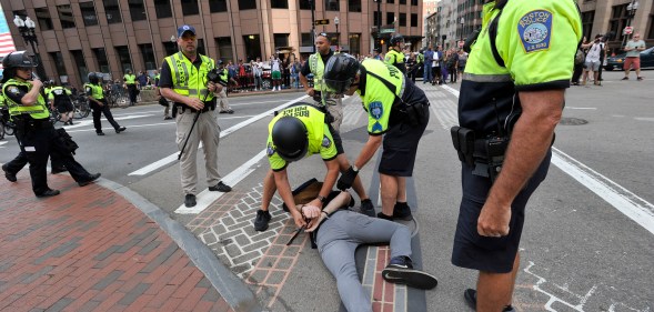 Boston Police officers arrest an anti-parade demonstrator during the "Straight Pride" parade in Boston, on August 31, 2019.